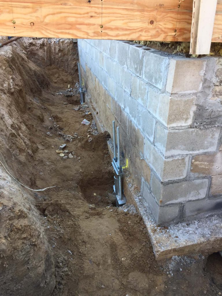 Underpinning bracket installed to support existing footings.